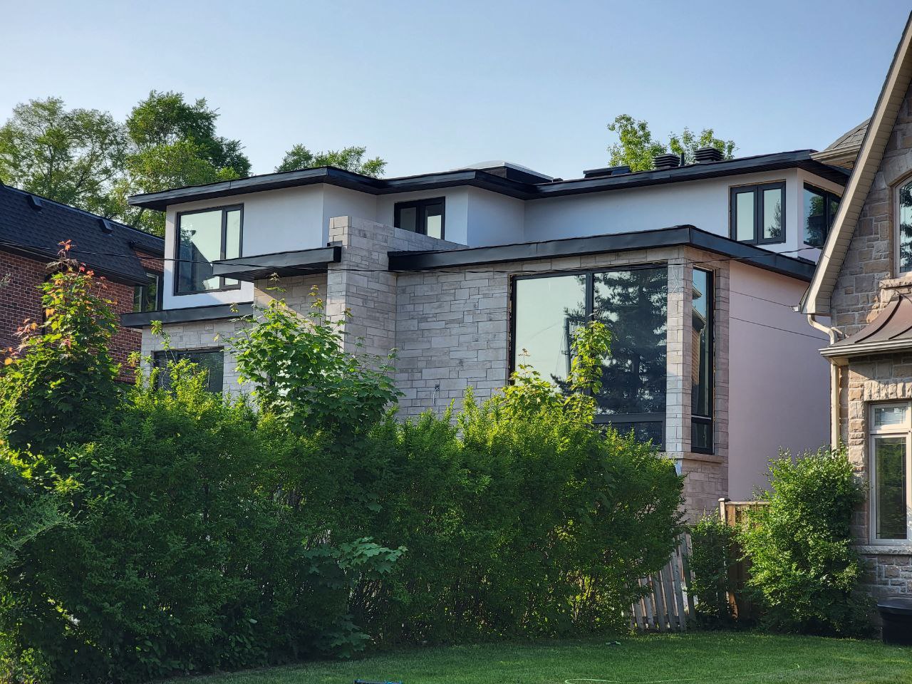 Front elevation of the modern Anndale Drive home, showcasing its geometric design and large windows